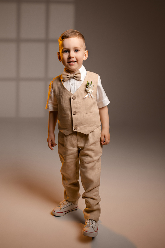 boys’ linen ring bearer suit set including tailored pants, vest, suspenders, and a bow tie