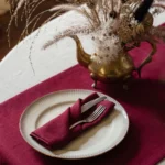 Burgundy linen table runner styled on a table for elegant event decor