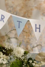 Happy Birthday linen bunting banner displayed as wall decoration