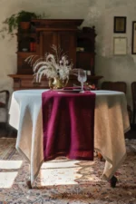 Burgundy linen table runner shown flat with natural linen texture