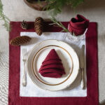 Burgundy linen napkin styled for a Christmas table setting