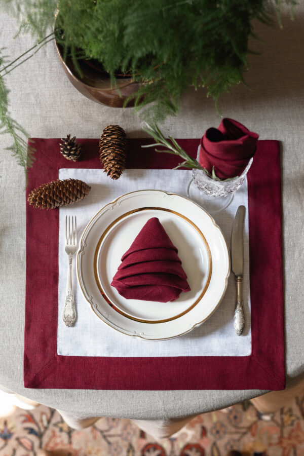 Burgundy linen napkin styled for a Christmas table setting